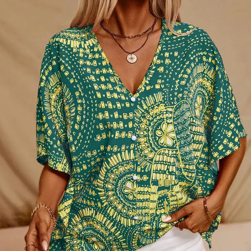 Top holgado de mujer con cuello en V y estampado, con mangas murciélago, ideal para vacaciones.