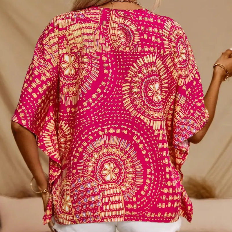 Top holgado de mujer con cuello en V y estampado, con mangas murciélago, ideal para vacaciones.